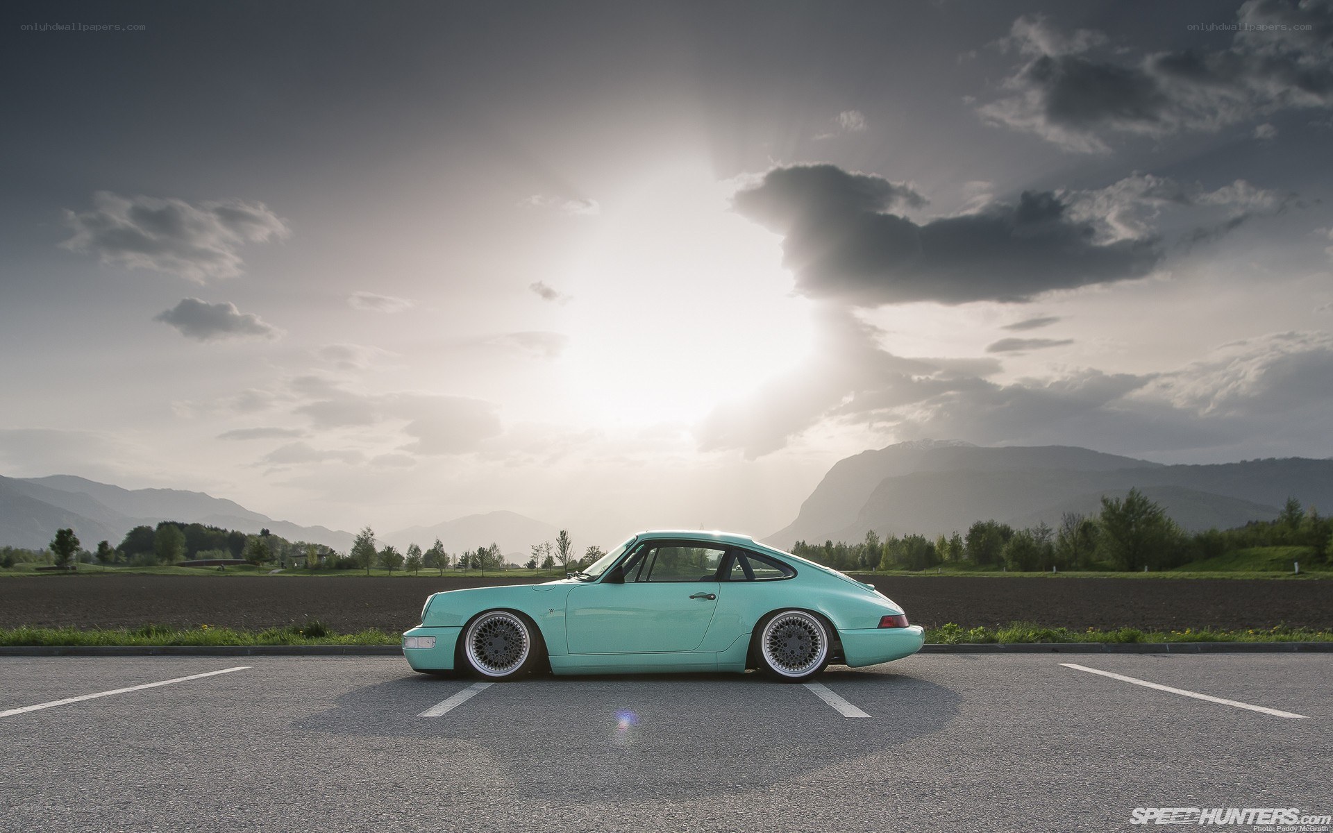 Teal Porsche on a road