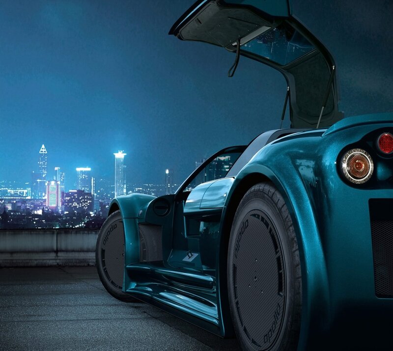 Teal sports car at night