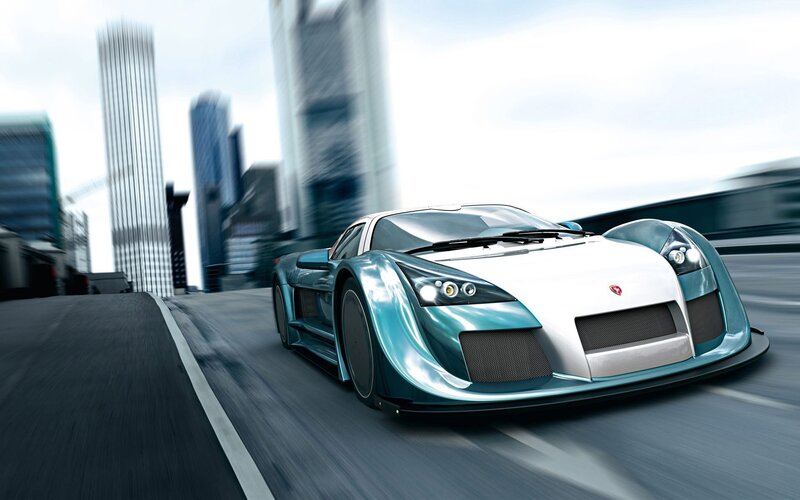 Teal sports car on city street