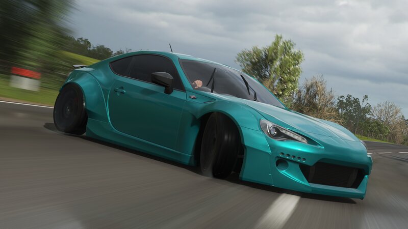 Teal Sports Car on Road — Dynamic
