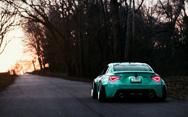teal sports car on road