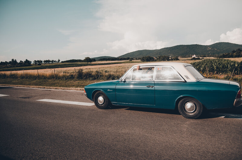 Teal Vintage Car on Road