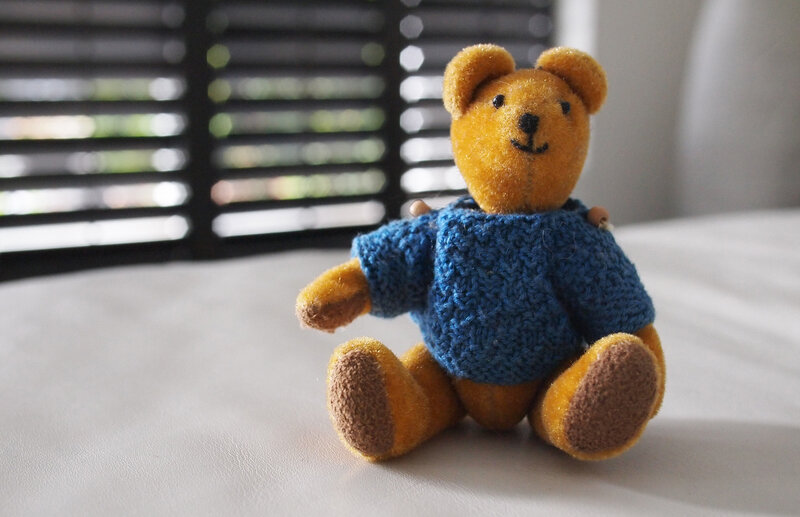 Teddy bear in blue sweater