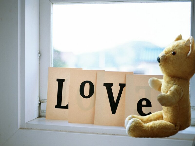 teddy bear with love sign