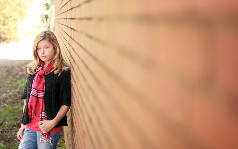 Teen Girl Leaning on Wall — Red, Contemplative