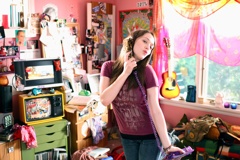 teen girl on phone in bedroom
