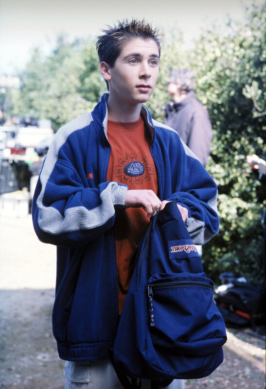 Teen holding a backpack