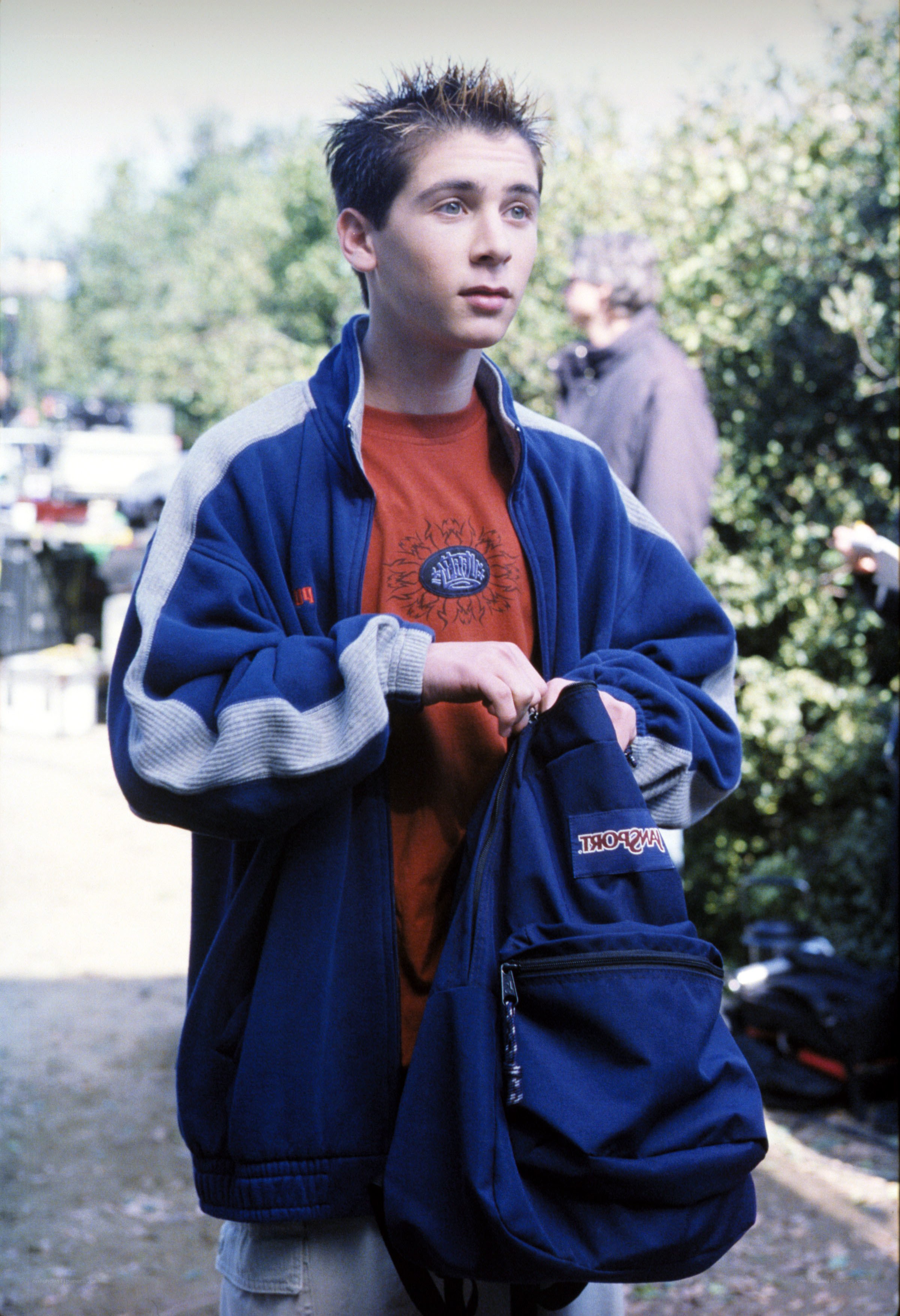 Teen holding a backpack
