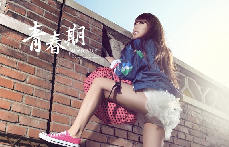 Teenage girl on brick wall