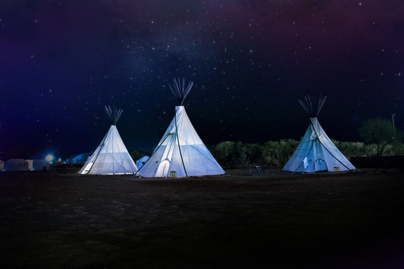 Teepees under a starry sky