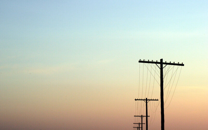 Telephone poles at sunset