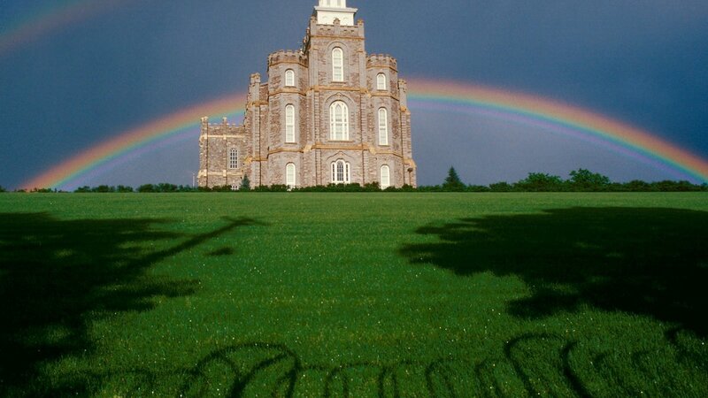 Temple with rainbow in field