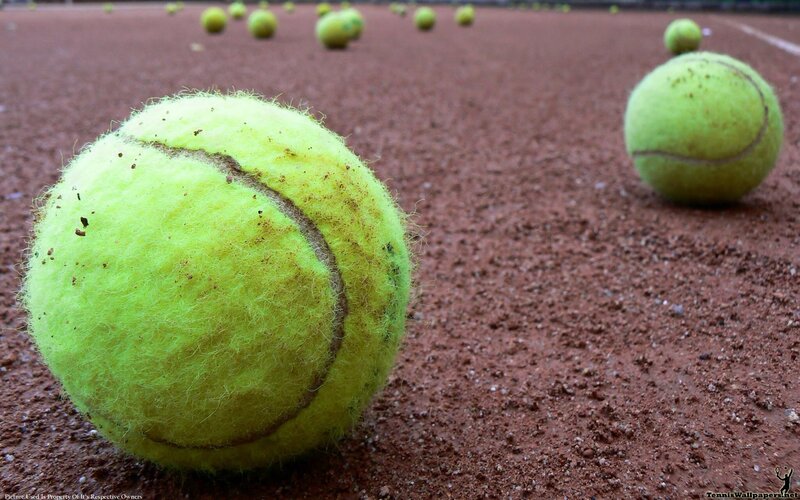 tennis balls on clay court
