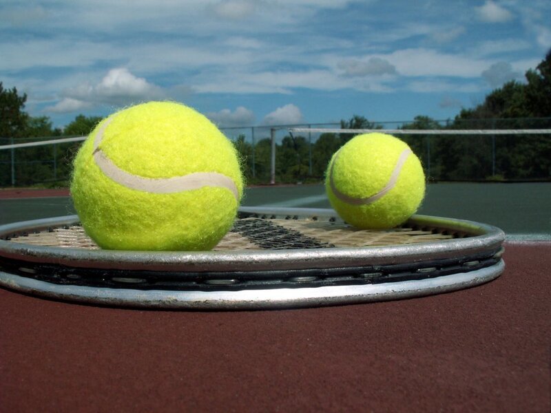 tennis balls on racket