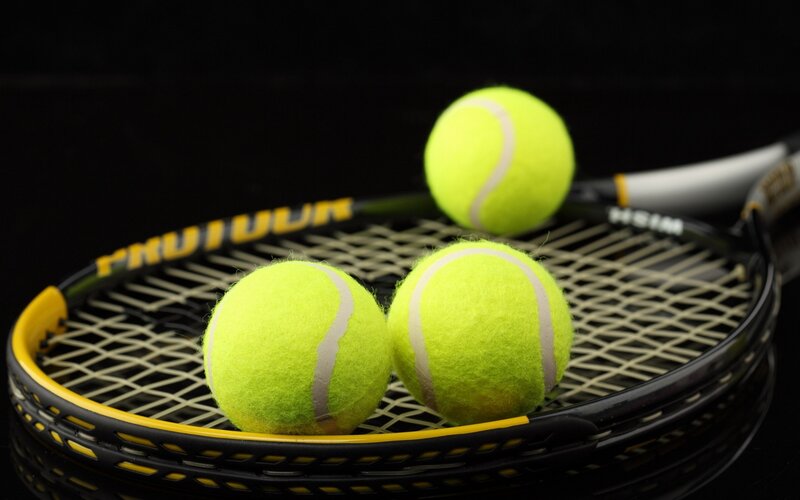 Tennis Balls on Racket — Yellow