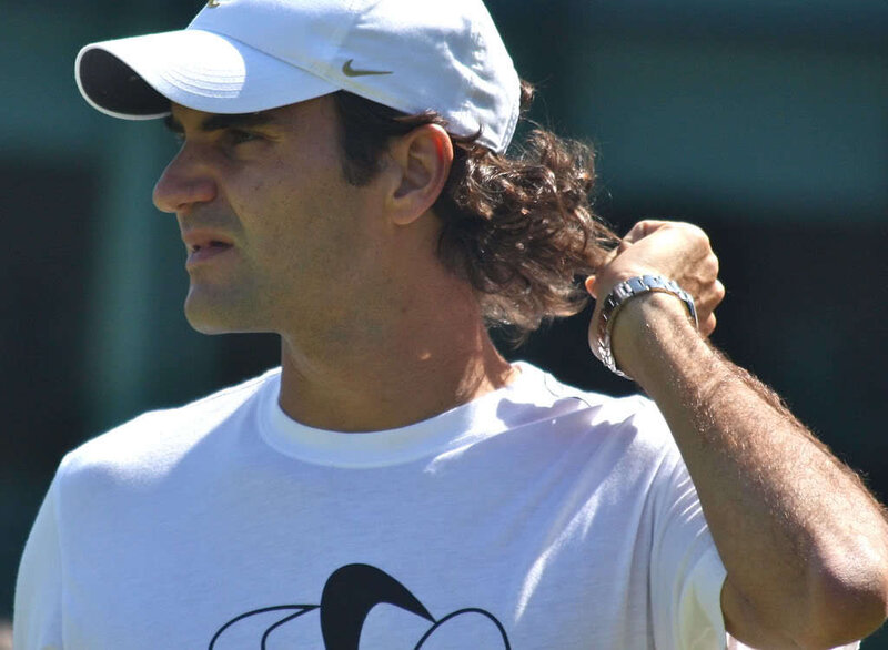 tennis player adjusting hair