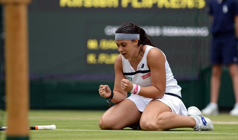 Tennis player celebrates on grass court