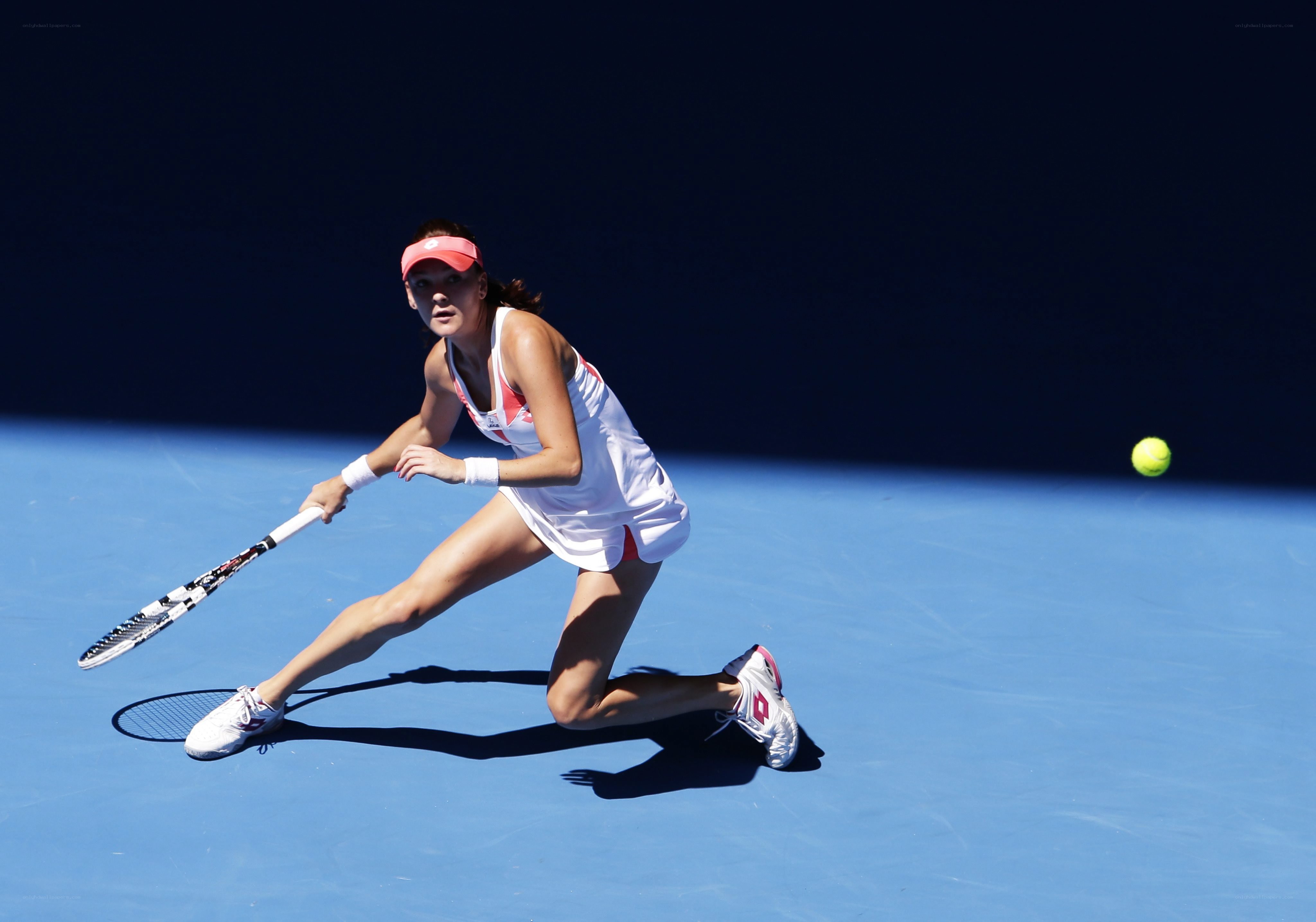 tennis player hitting a forehand