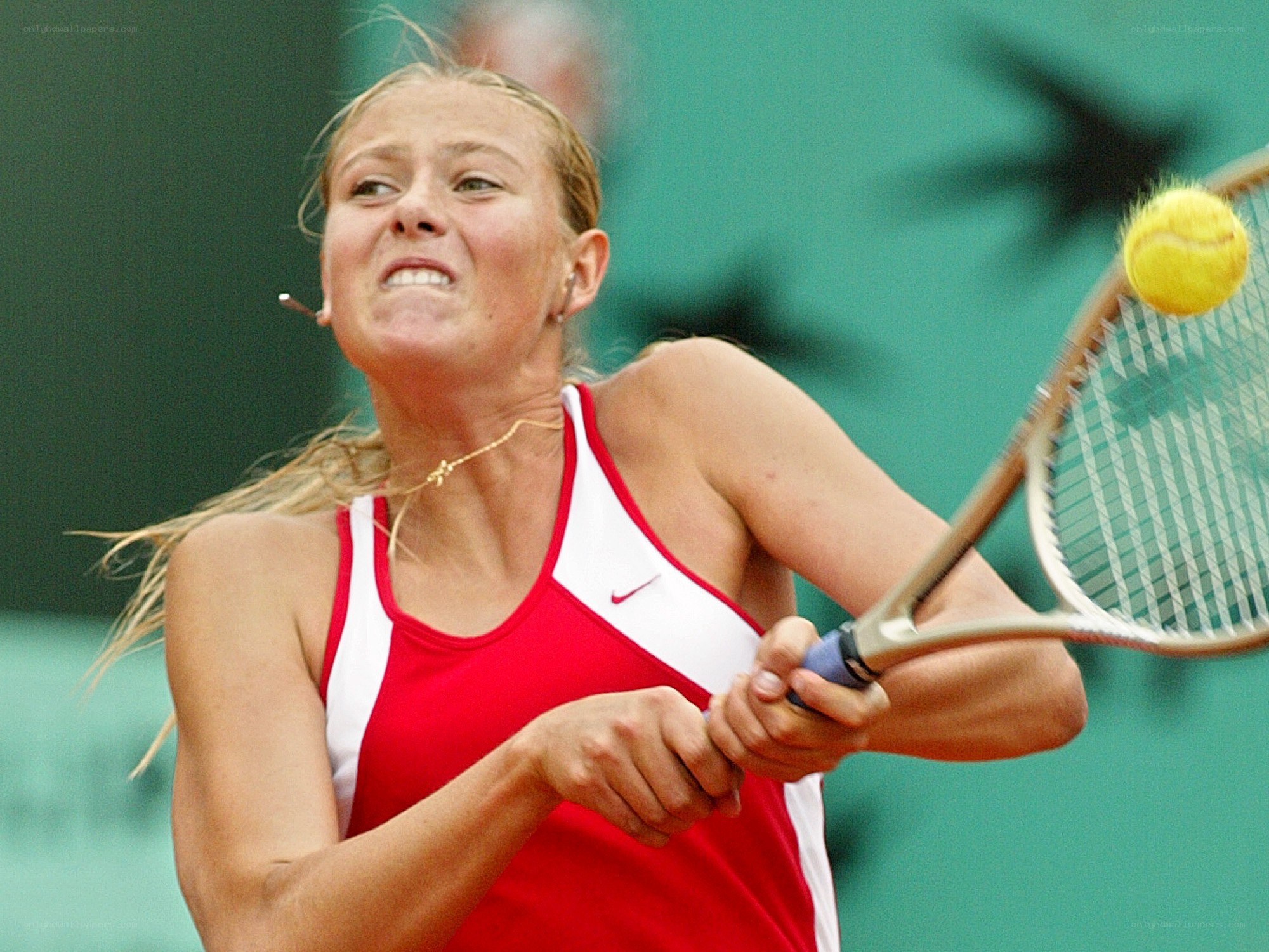 tennis player hitting ball