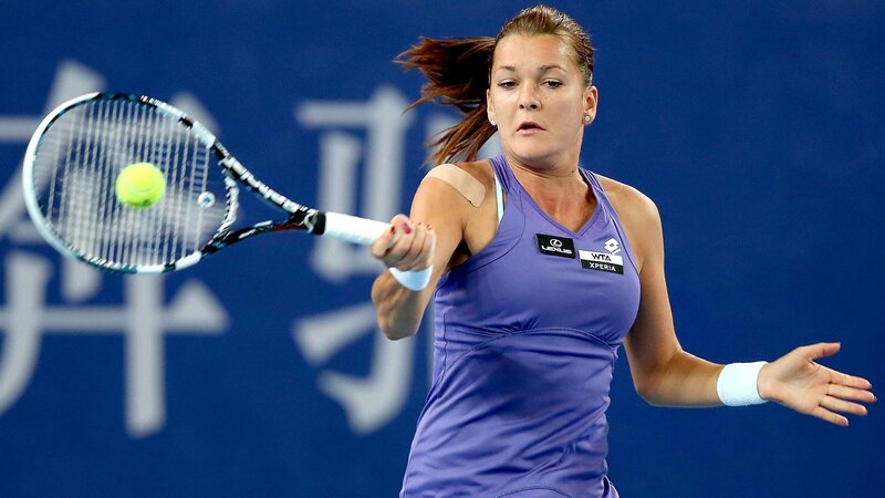 tennis player hitting ball