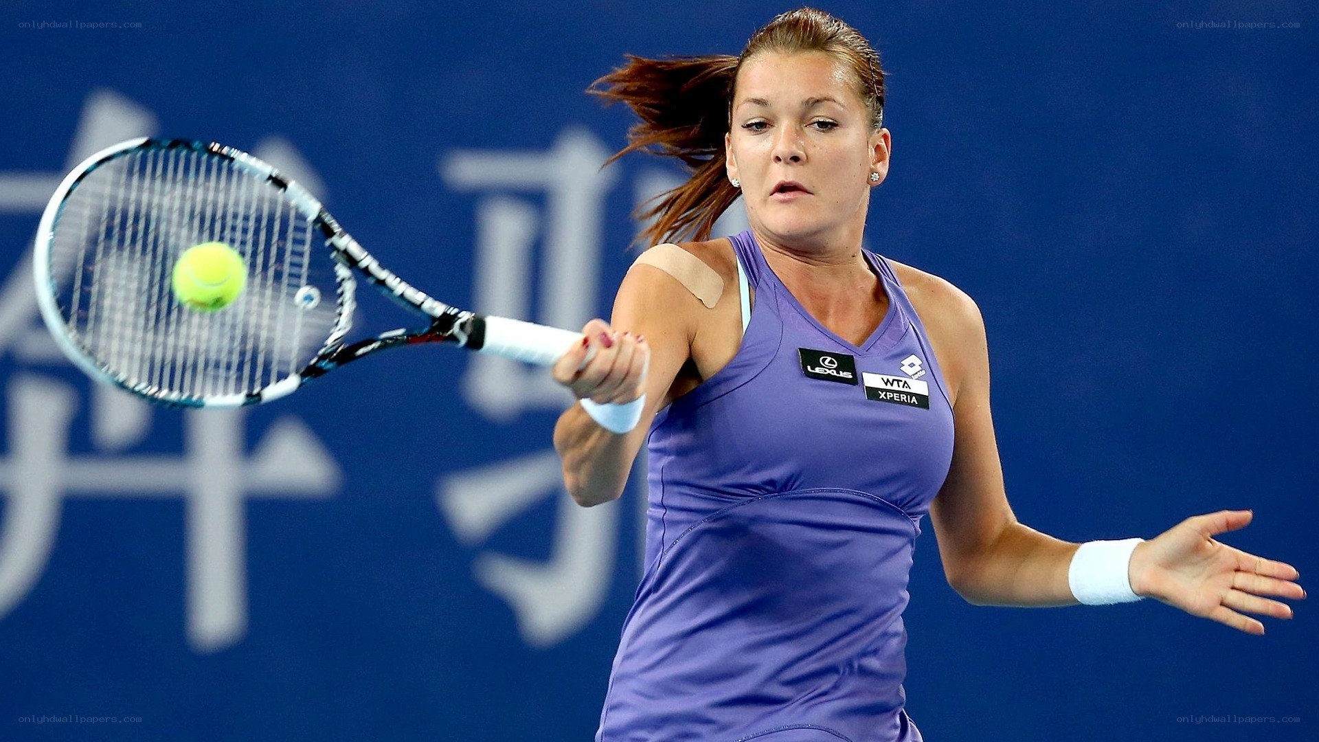 tennis player hitting ball