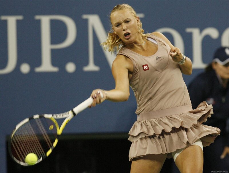 tennis player hitting ball