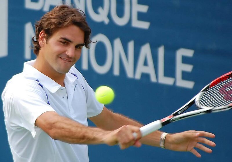 tennis player hitting ball