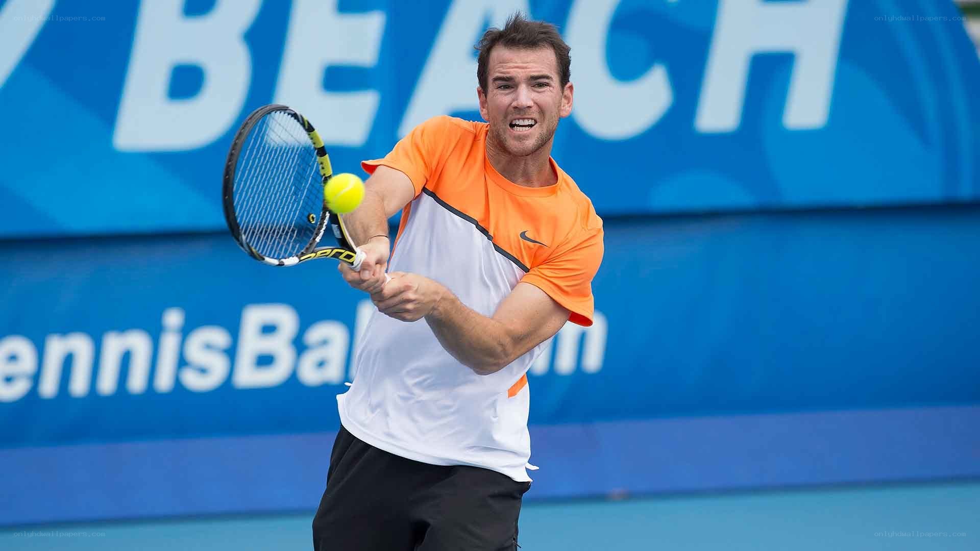 tennis player hitting ball
