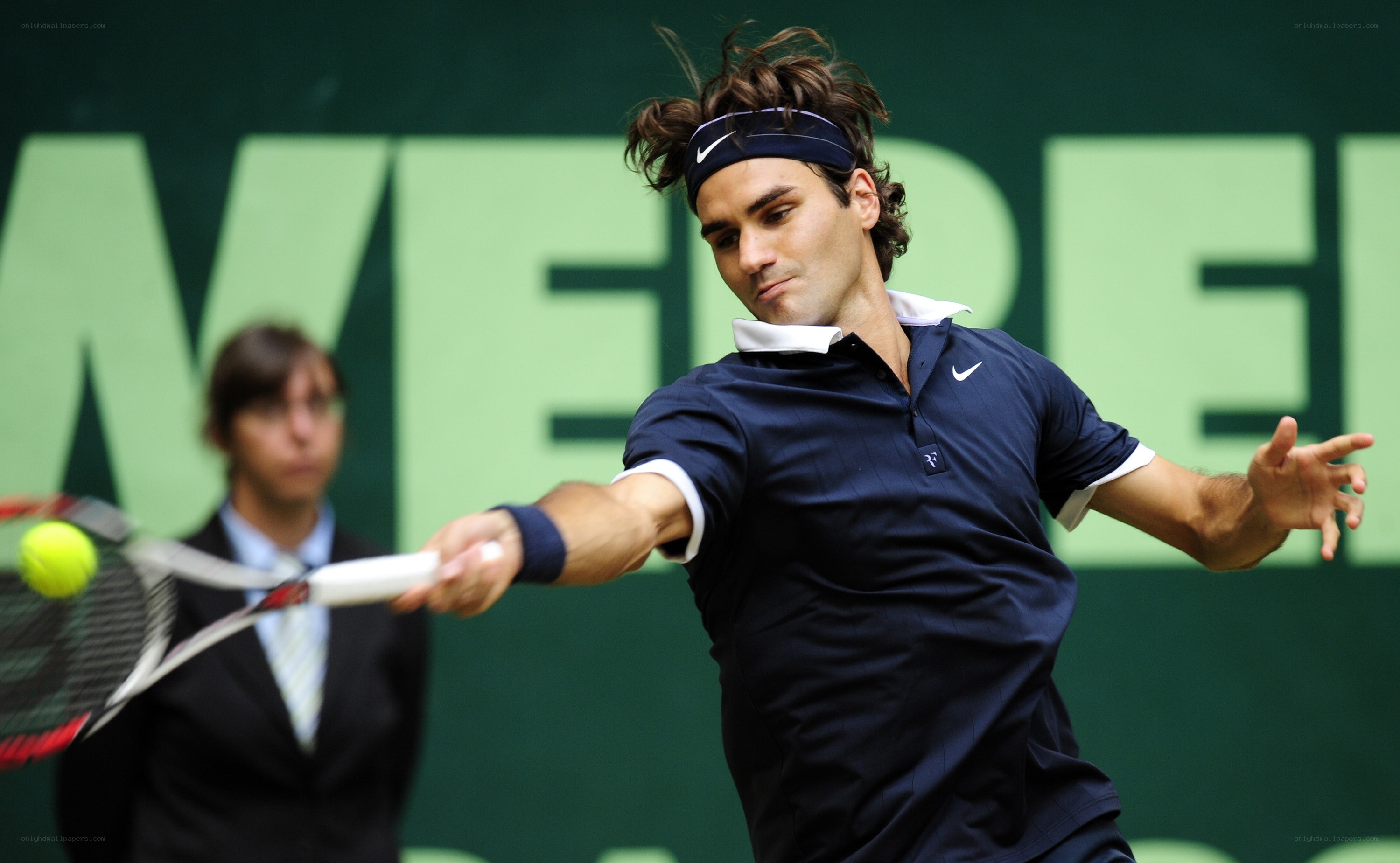 tennis player hitting ball