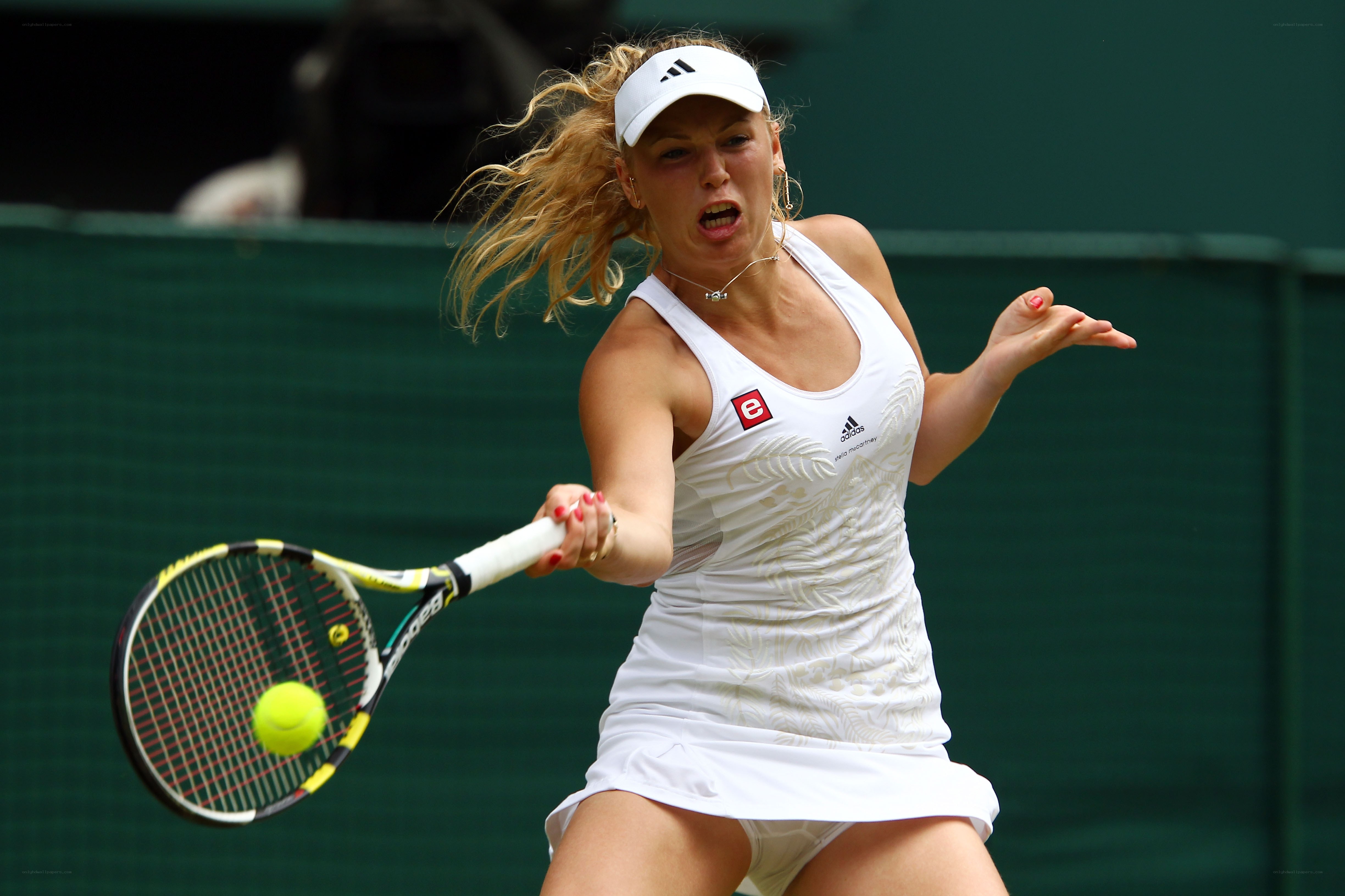 tennis player hitting ball