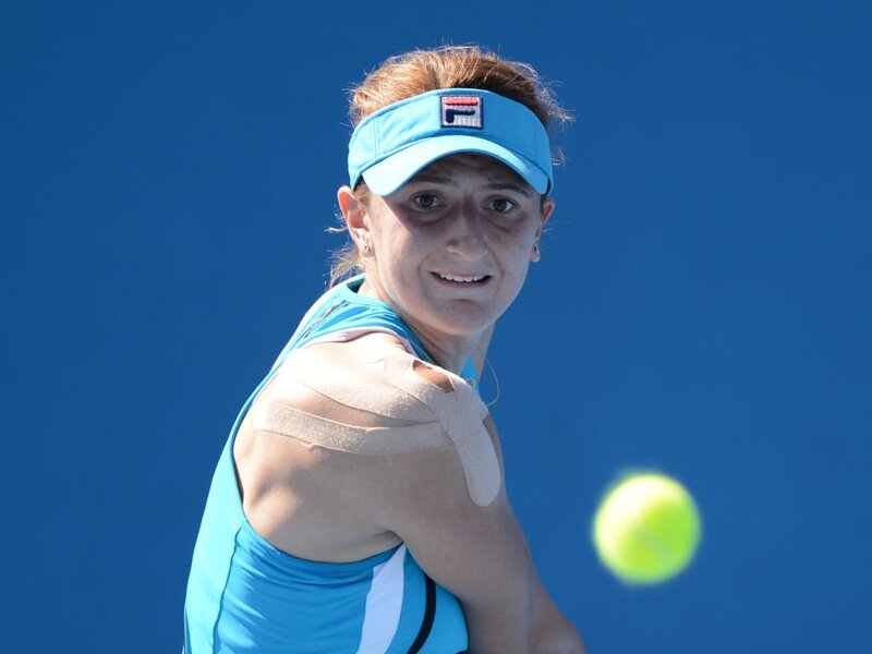 Tennis Player Hitting Ball — Blue, Focused, Afternoon