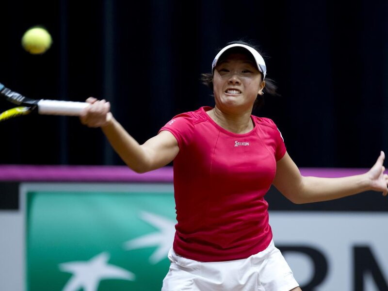 Tennis Player Hitting Ball — Red, Intense, Photograph