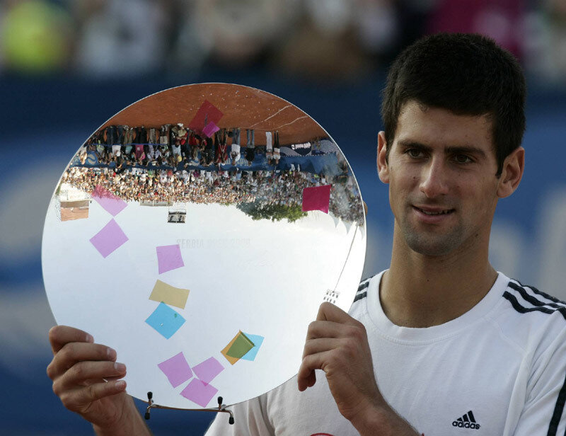 tennis player holding trophy