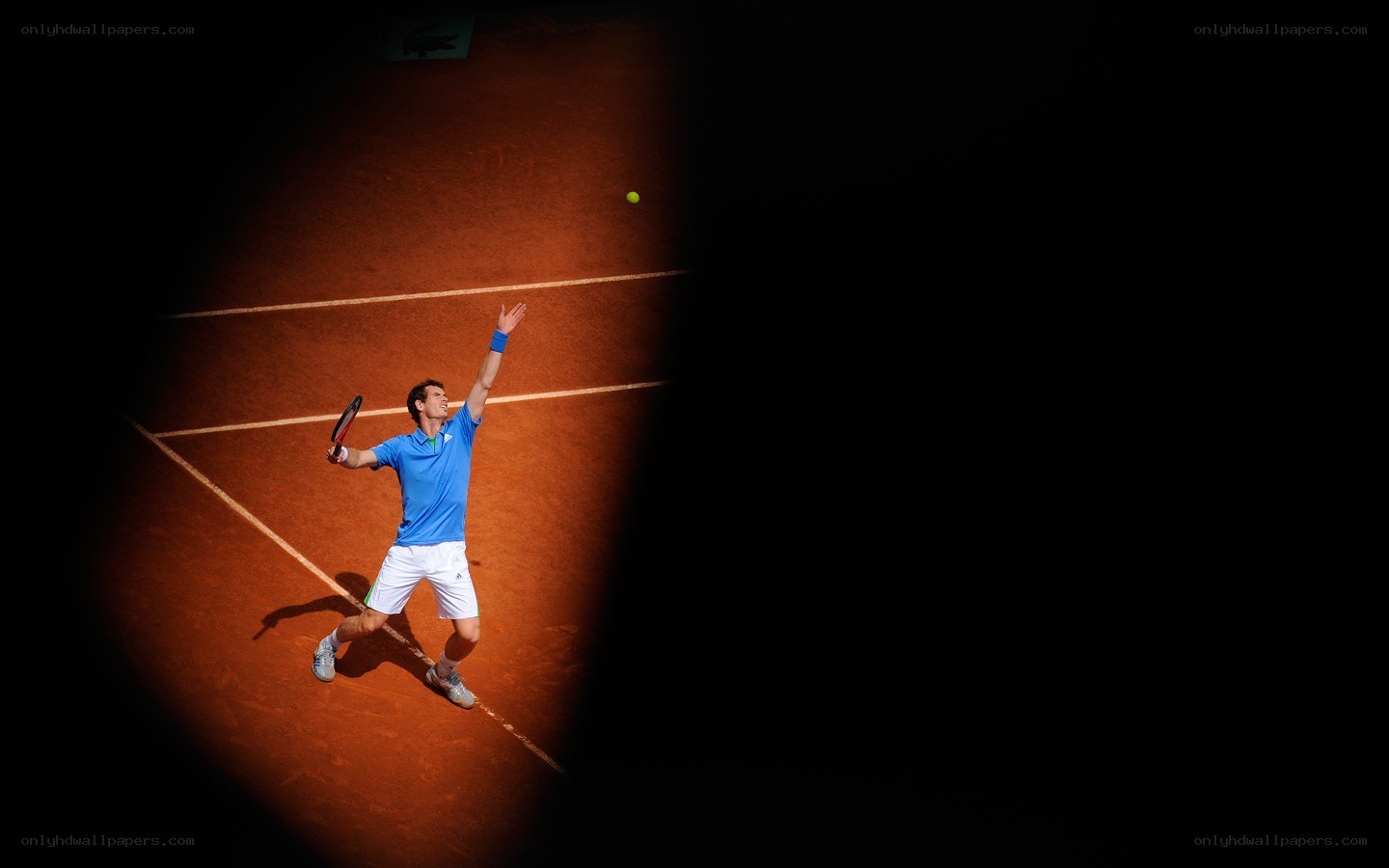 tennis player serving on clay court