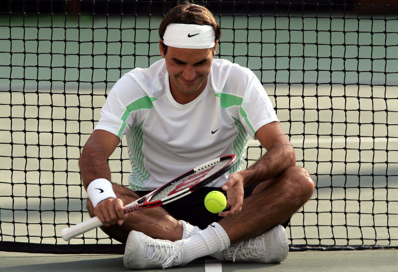 Tennis player sitting on court