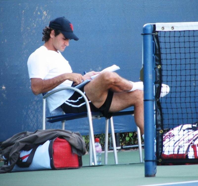 tennis player writing on court