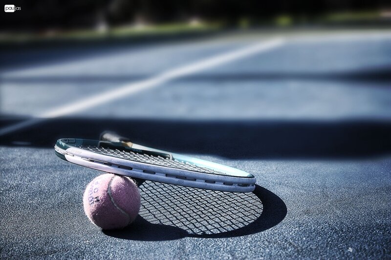 tennis racket and ball on court