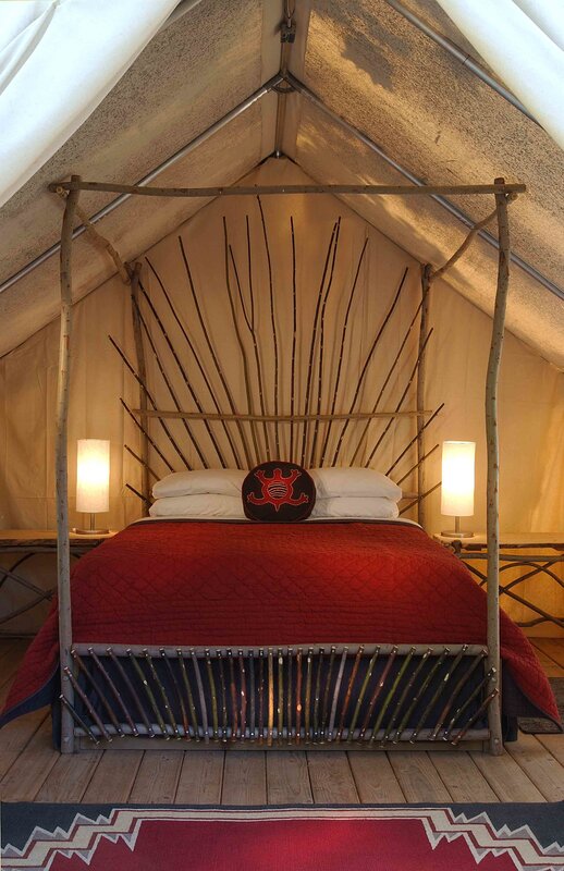Tent bedroom with rustic bed