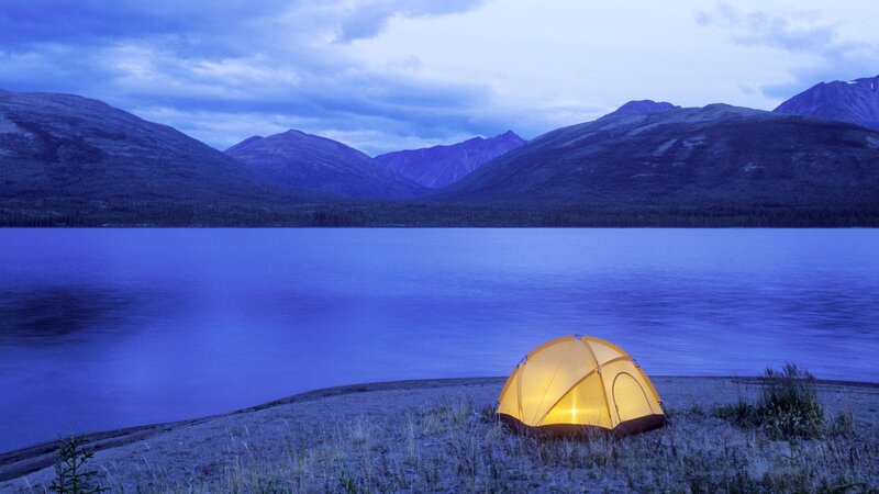 tent by lake at dusk
