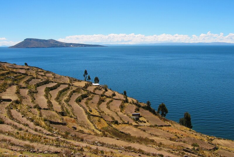 Terraced hillsides by a large lake
