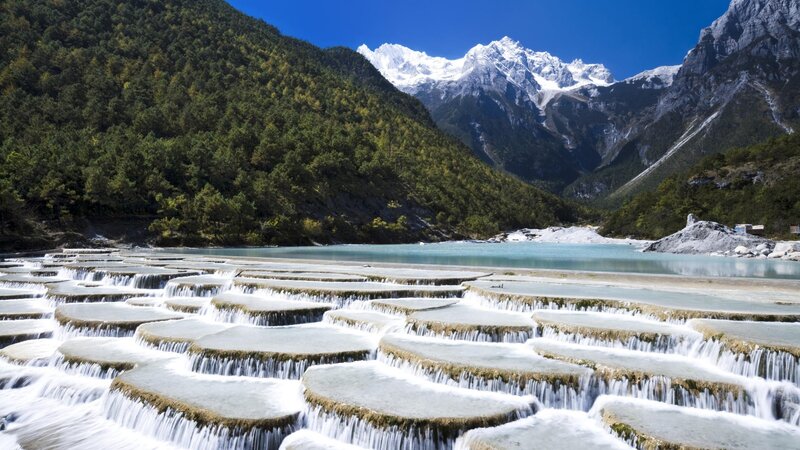 Terraced waterfalls and snow-capped mountains
