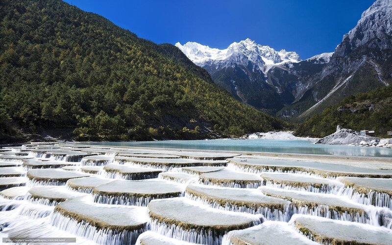Terraced waterfalls and snow-capped mountains