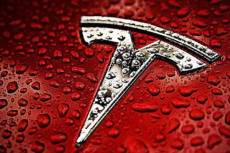 Tesla Logo on Red Surface