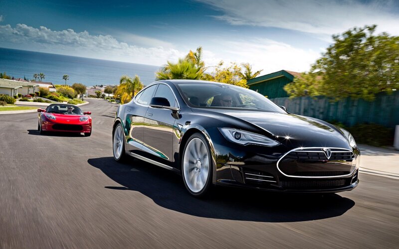 Tesla Model S and Roadster on coastal road