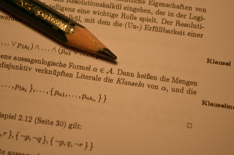 Textbook page with pencil