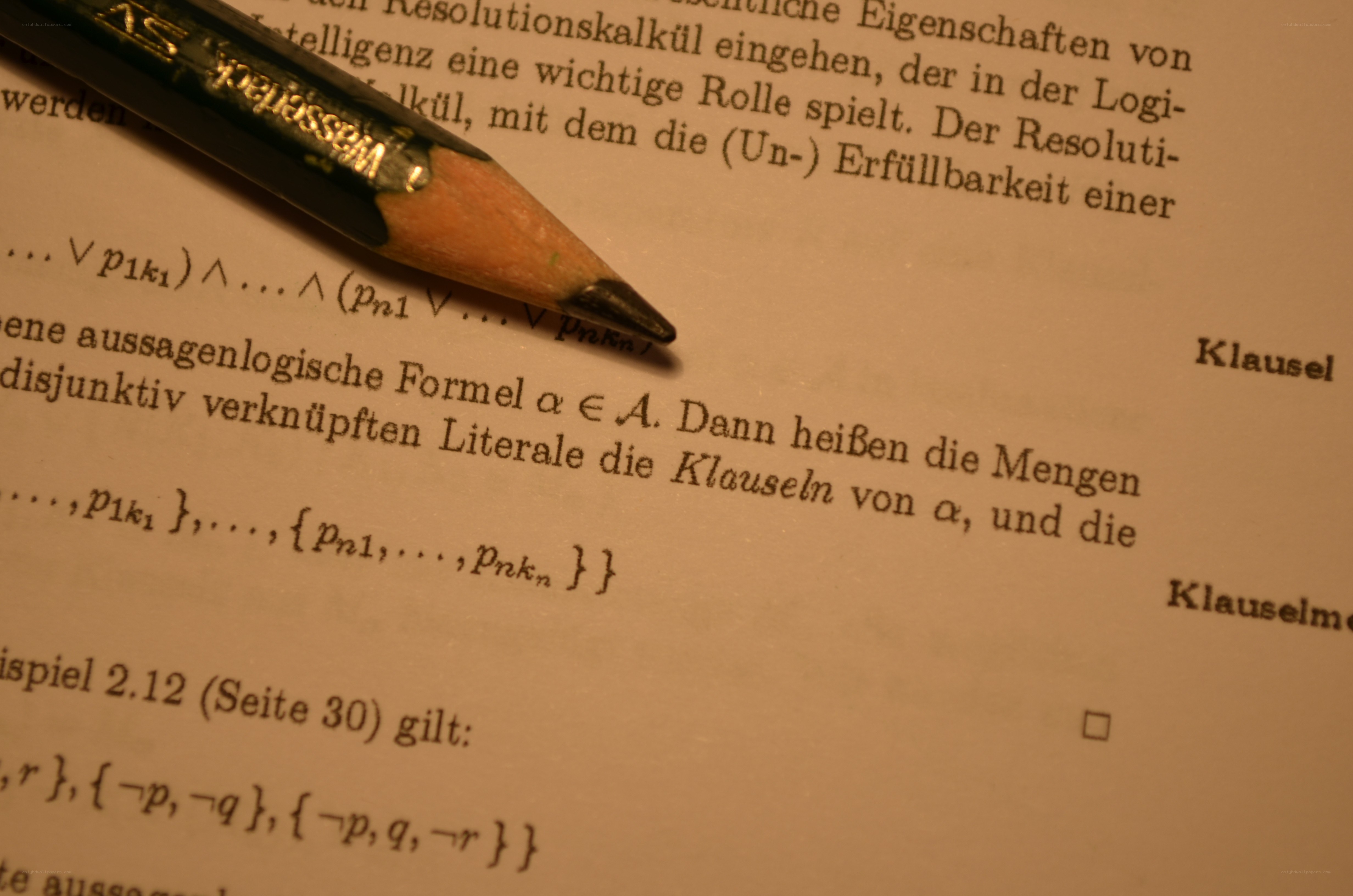 Textbook page with pencil
