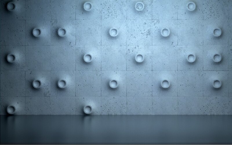 textured concrete wall with circular indentations