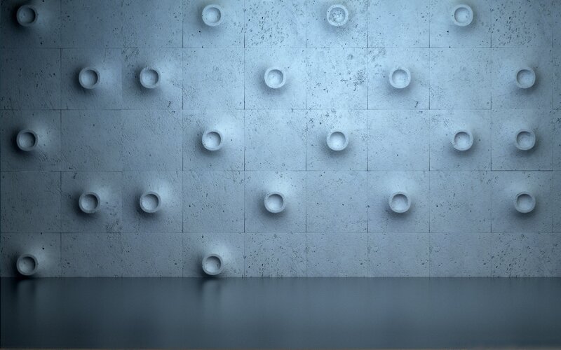 textured concrete wall with circular indentations