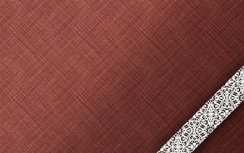 textured red fabric with lace trim