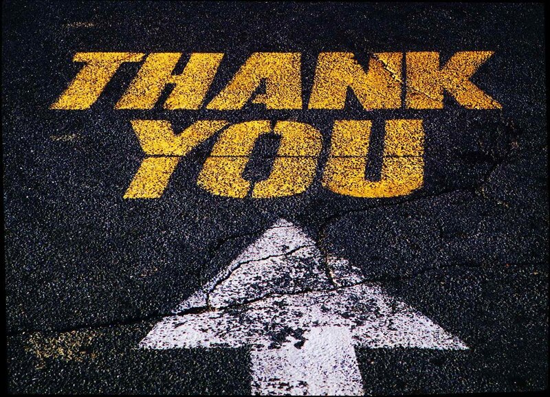 Thank you painted on asphalt
